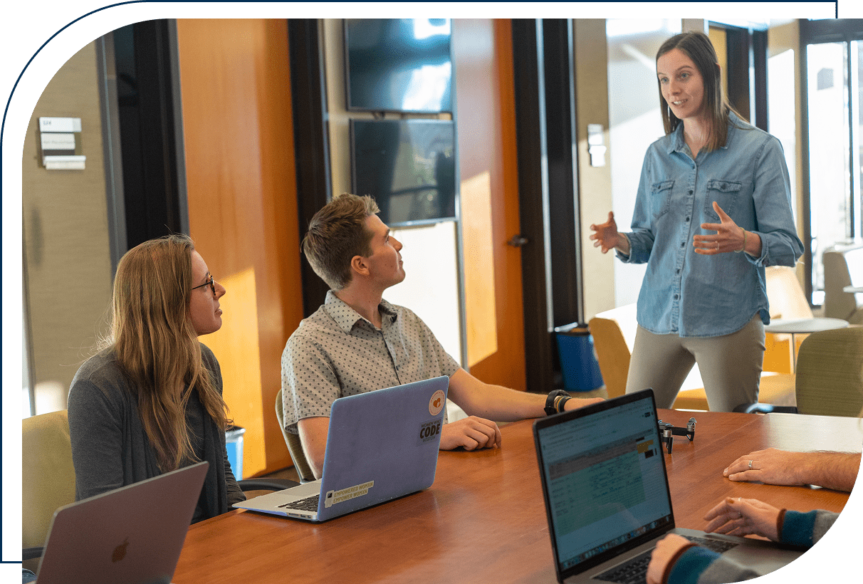 Team meeting with woman presenting ideas.