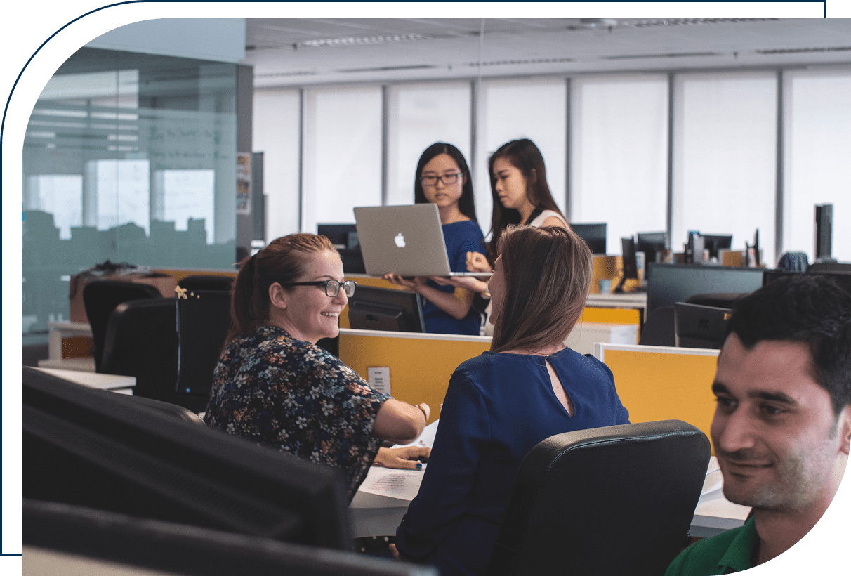 Office team collaborating in open workspace.
